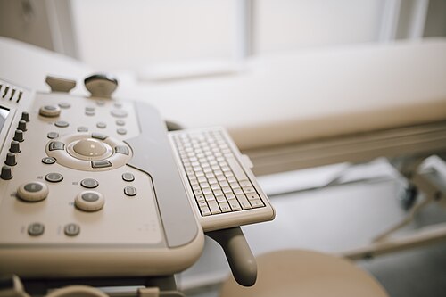 Ultrasound machine control console and probe, with no patient present.